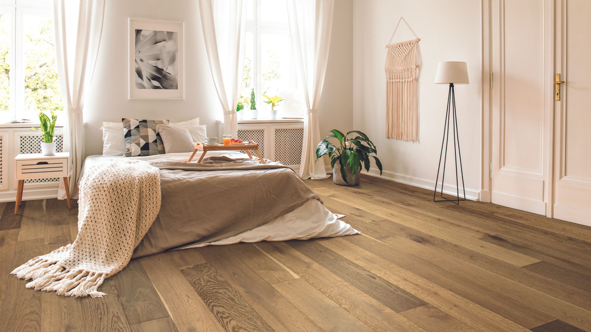 Laminate wood flooring in a bohemian style bedroom.